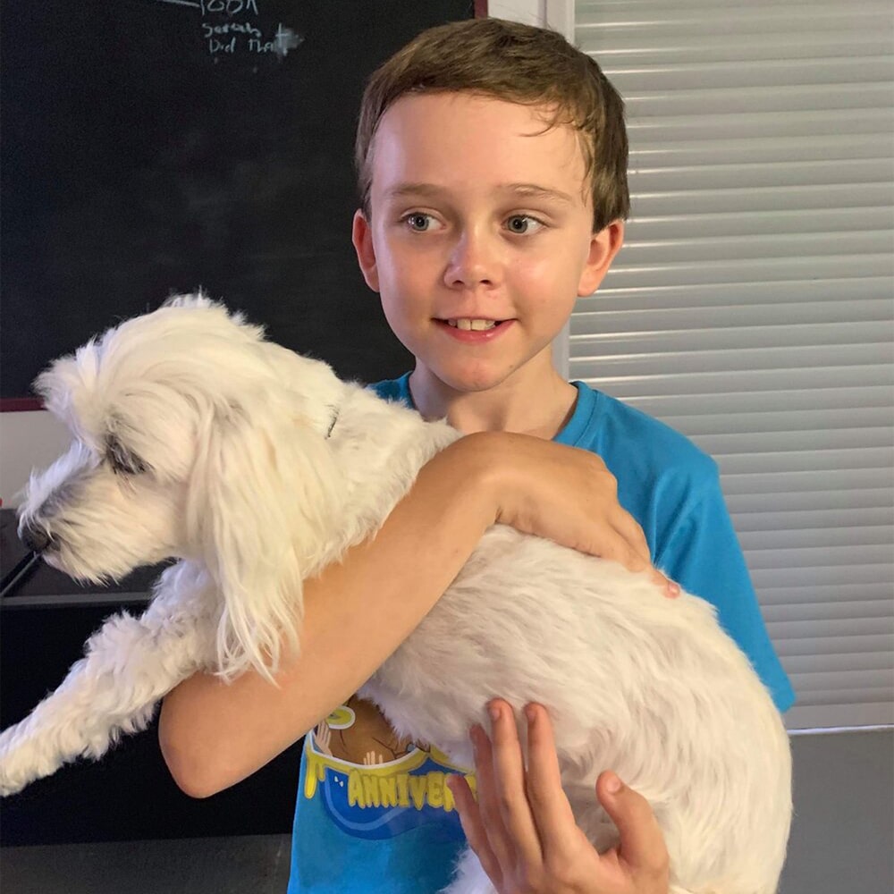 strength-potential-review-small-boy-holding-dog-participating-in-mentoring